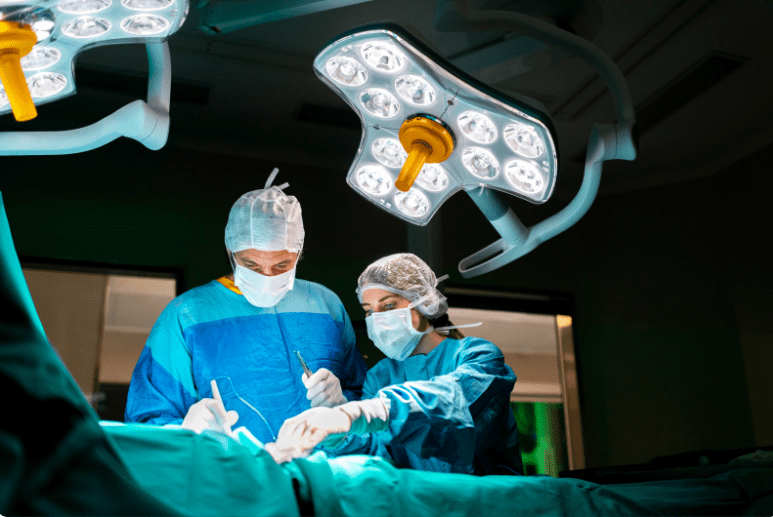 Surgeons and medical professionals turning on surgical lights before the procedure.