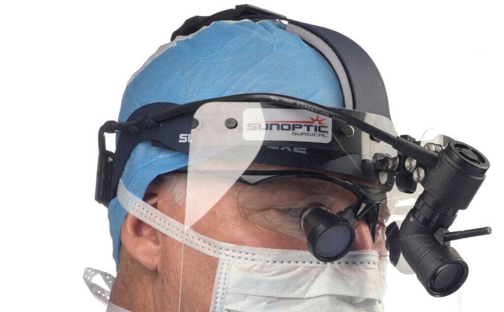 A surgeon wearing a surgical headlight that was carefully chosen for the operation he is about to perform 